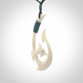 Hand carved bone hook with dolphin. This is a marine-themed pendant which we have made for dolphin lovers and for those of us that love the sea. This piece is handcarved from natural bone  and is shipped worldwide free.